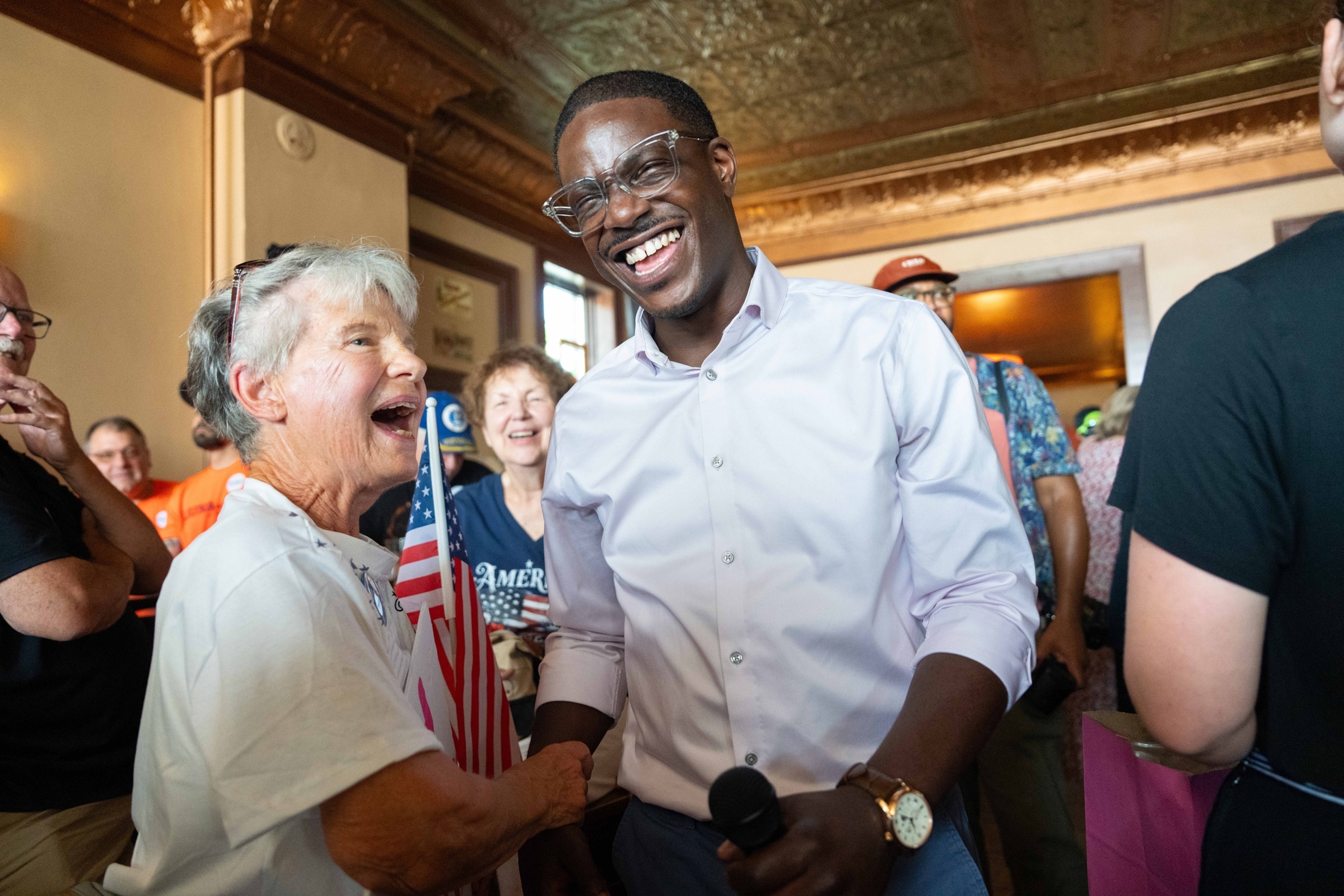 David Crowley, Democratic candidate for Wisconsin governor, shakes hands with Karen Hilt, left, during a campaign stop, Aug. 7, 2026, in Sheboygan, Wis.Kayla Wolf/AP