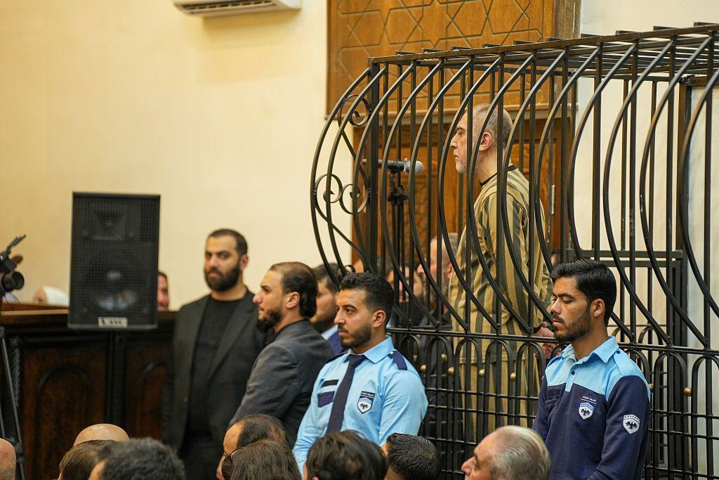 Image caption,Atef Najib appeared in a cage in court during his sentencing on Tuesday
