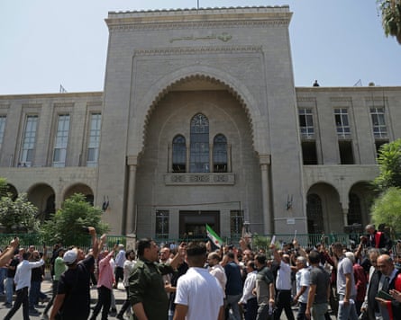 Syrians celebrate the ruling outside the palace of justice in Damascus.Photograph: Bakr Alkasem/AFP/Getty Images