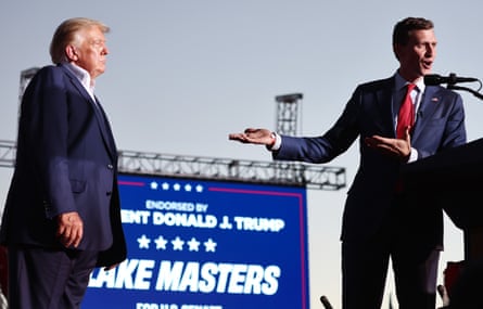 Then Republican candidate for US Senate Blake Masters speaks as Donald Trump looks on during a campaign rally for Arizona Republicans in Mesa, Arizona, on 9 October 2022.Photograph: Mario Tama/Getty Images