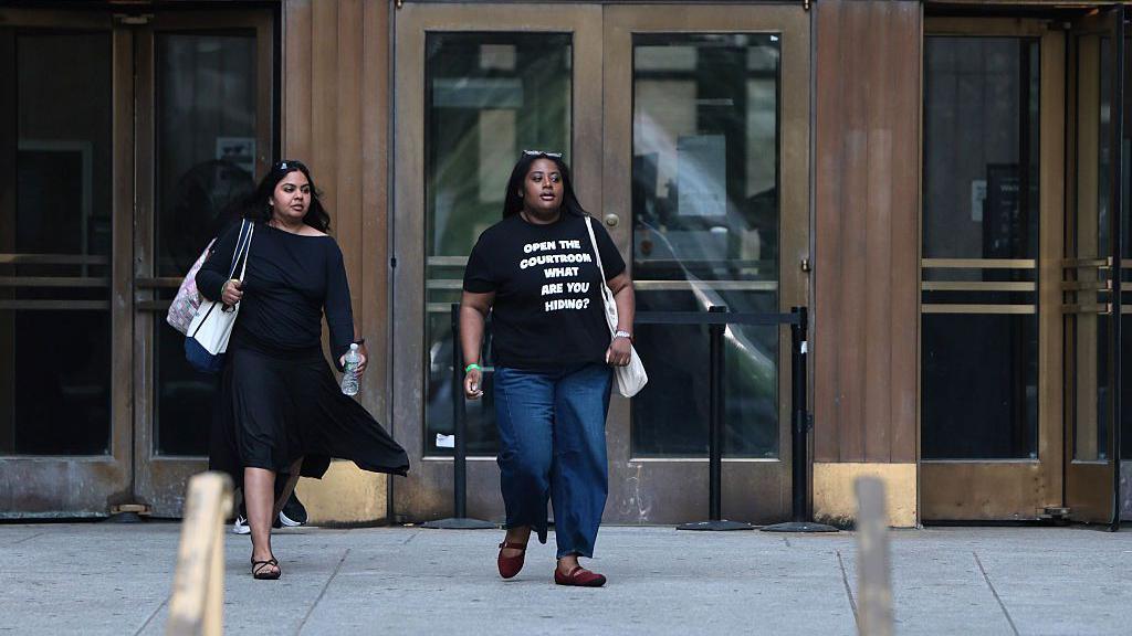 Image caption,Mangione's defence team leave court. Pictured from left to right: Marc Agnifilo, Karen Friedman Agnifilo, and Jacob Kaplan.