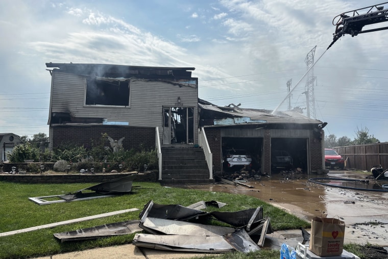 McKee outside her house after it caught fire Tuesday.Selina Guevara / NBC