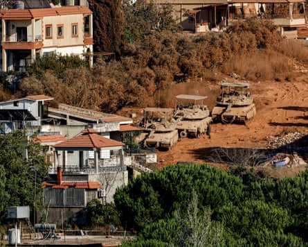 Israeli tanks make their way through the village of Zawtar al-Sharqiyah in southern Lebanon on 2 August.Photograph: Ammar Ammar/AFP/Getty Images