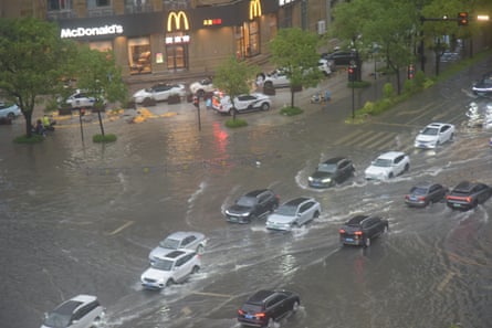 Cars drive on a flooded street following heavy rain brought by Typhoon Dolphin in Taizhou, Zhejiang province.Photograph: VCG/Getty Images