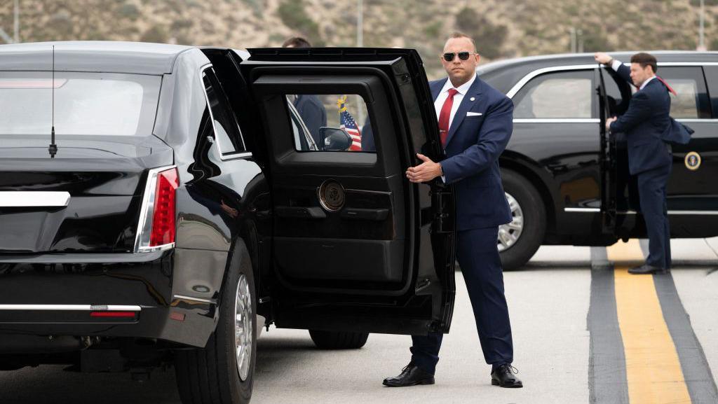 Image caption,The order of vehicles travelling in the US president's massive motorcade is often switched en route