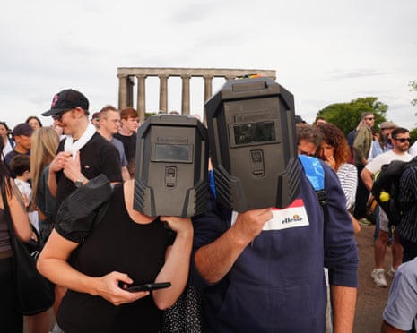 People gathering to watch the solar eclipse on Calton Hill, Edinburgh, the first total solar eclipse visible over mainland Europe since 1999.Photograph: Jane Barlow/PA