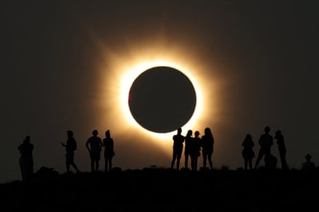 Artists use self-made artefacts to observe a solar eclipse before totality near the small village of Castell de Cabres, SpainPhotograph: Eva Manez/Reuters