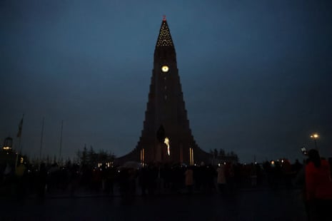 People gather to observe the total solar eclipse, as clouds cover the sky, in ReykjavikPhotograph: Denis Balibouse/Reuters