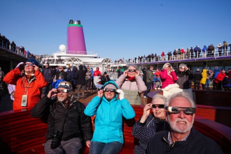 Passengers on board the Ambassador cruise ship Ambition watching the start of the total solar eclipse off the coast of GreenlandPhotograph: Owen Humphreys/PA
