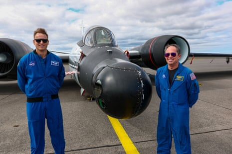 Cary Klemm, sensor equipment operator, and pilot John Gustine of Nasa’s Johnson Space Centre pose in front of a WB-57 Canberra aircraftPhotograph: Denis Balibouse/Reuters