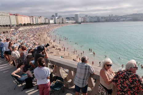 People wait for a solar eclipse at the beach in A Coruña, SpainPhotograph: Lavandeira/EPA