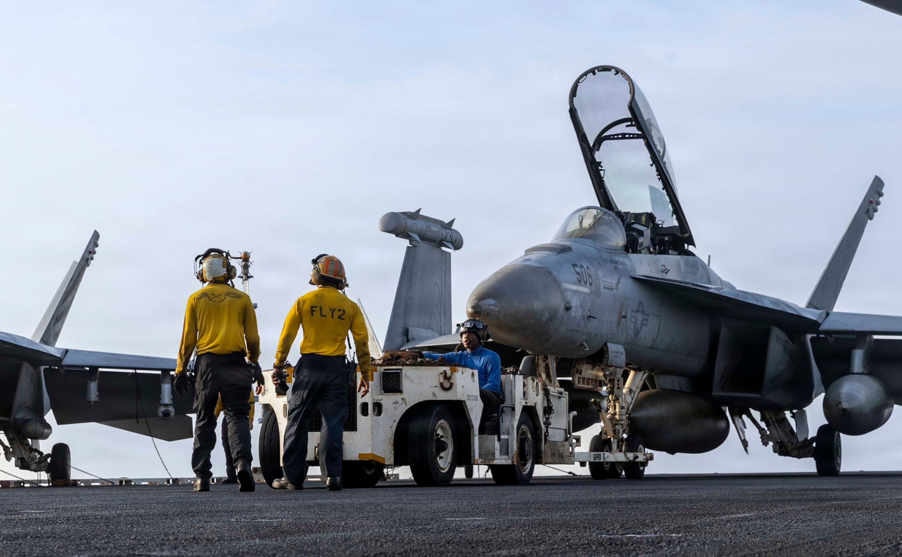U.S. Sailors tow an EA-18G Growler, assigned to Electronic Attack Squadron 133, on the flight deck of Nimitz-class aircraft carrier USS Abraham Lincoln, July 30, 2026.US Navy