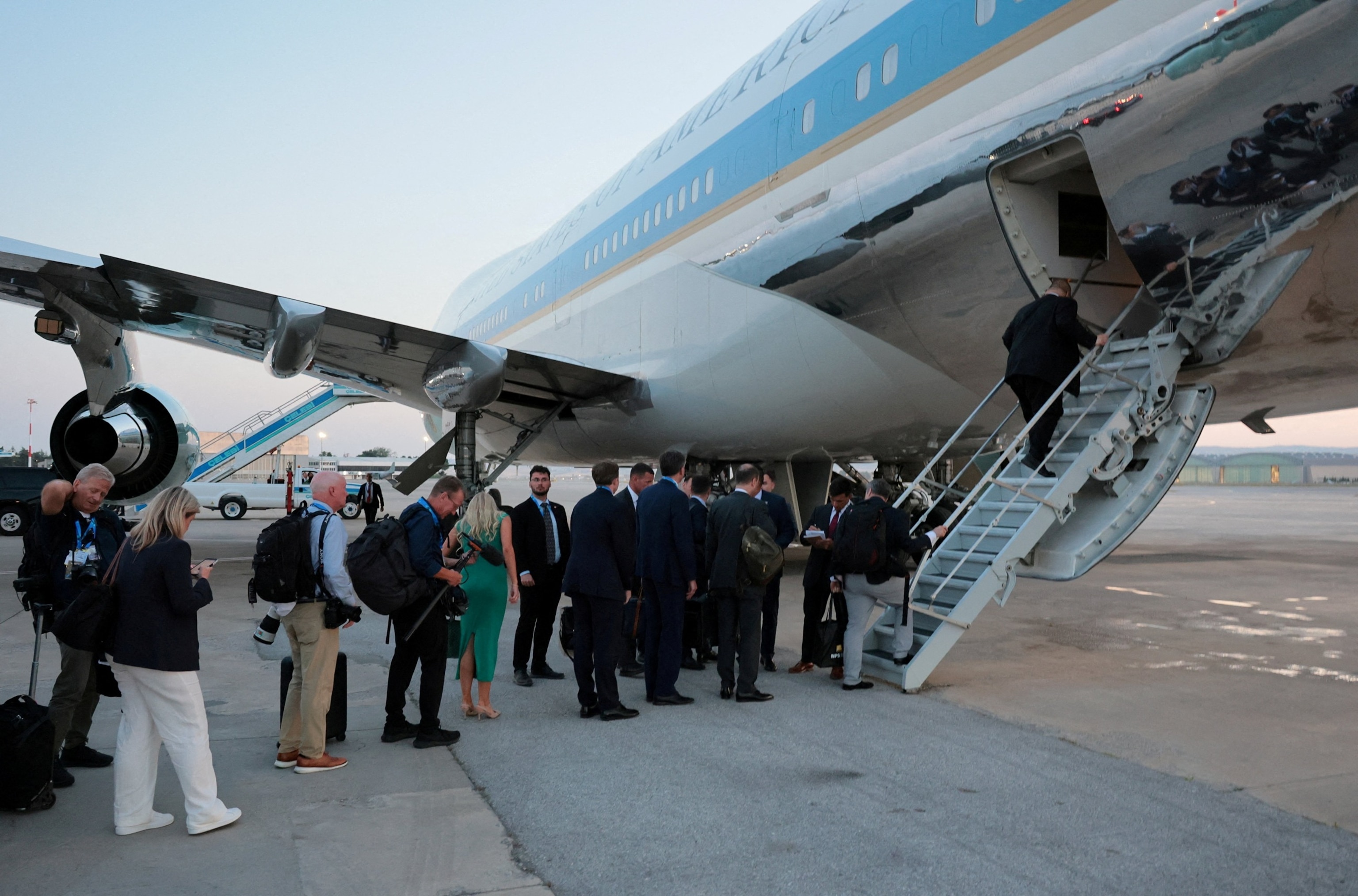 FILE PHOTO: People board Air Force One carrying U.S. President Donald Trump, en route to Washington after his participation in the NATO leaders' summit, at Ankara Esenboga Airport in Ankara, Turkey, July 8, 2026.Jonathan Ernst/Reuters