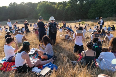 Parliament Hill, Hampstead Heath. The eclipse was a chance to hang out and do crafts.Photograph: Denise Baker/Getty