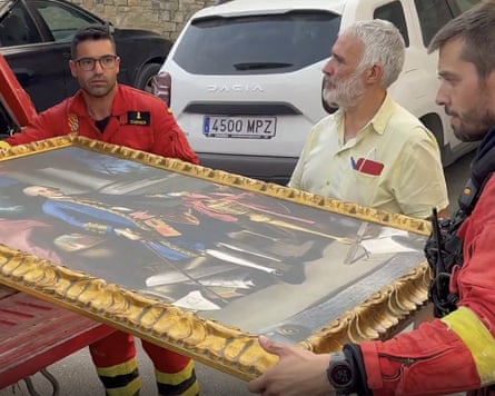 A painting is removed as a wildfire nears the San Juan de la Peña monastery in Aragón, north-east Spain.Photograph: UME/AFP/Getty Images