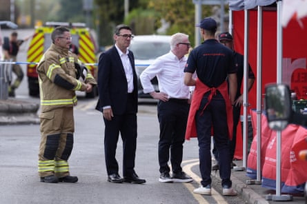 Andy Burnham and the West Midlands mayor, Richard Parker (third from right), met fire service staff in Stourbridge on FridayPhotograph: Peter Byrne/AFP/Getty Images