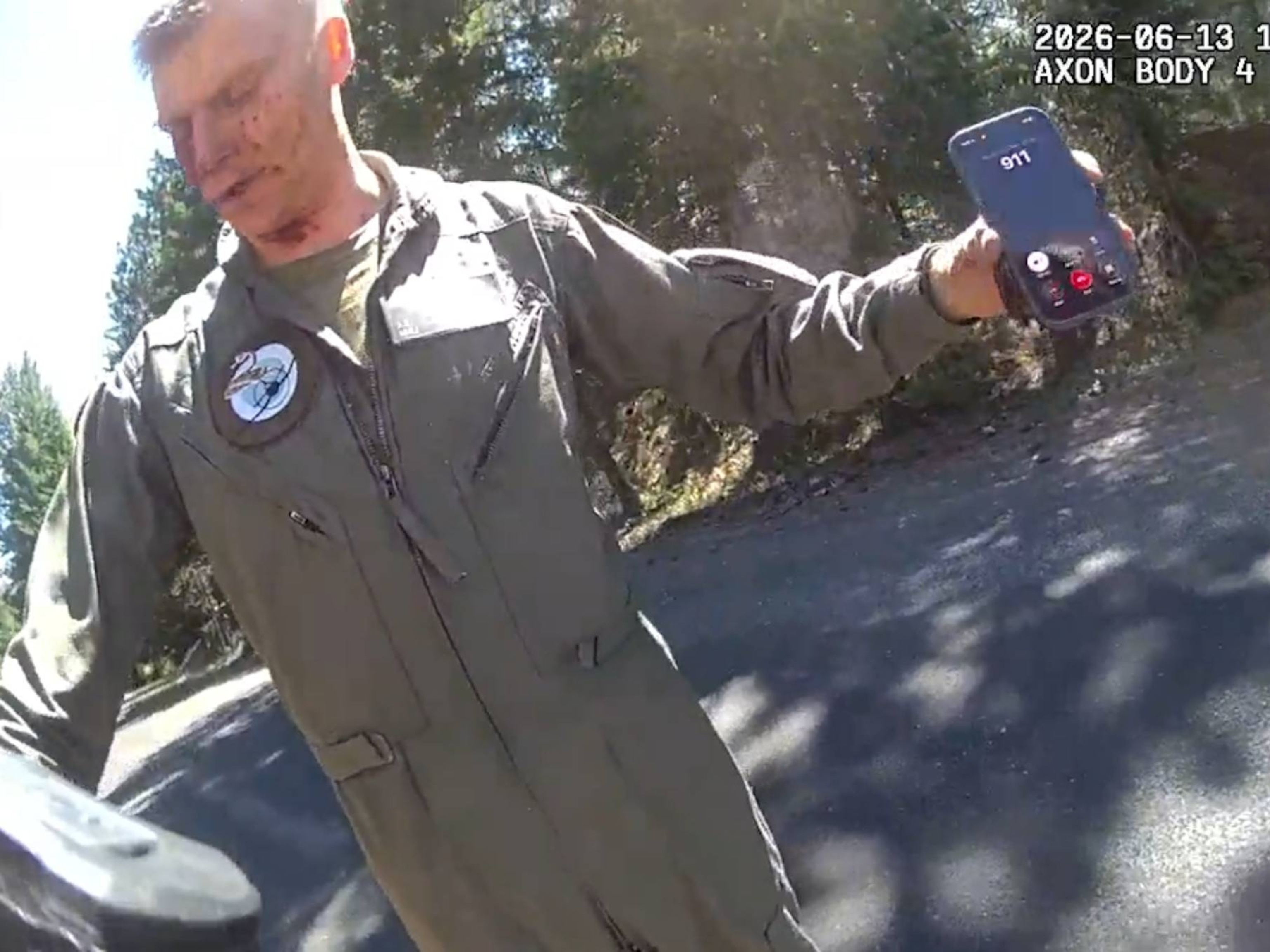 A still photo from body camera footage released by the Yakima County Sheriff's Office on Aug. 14, 2026, shows the moments local authorities encountered a pilot who had ejected from a military jet before it crashed in June.Yakima County Sheriff's Office