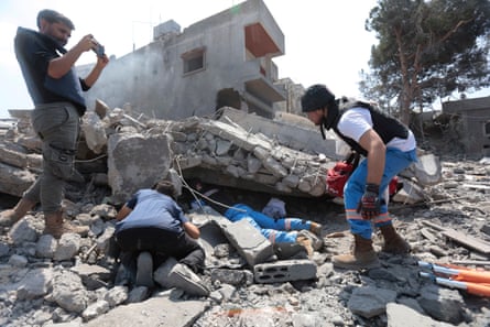 Rescue workers and residents search for survivors after an Israeli airstrike on Deir al-Zahrani in southern Lebanon.Photograph: Abdul Kader Al Bay/Zuma Press Wire/Shutterstock
