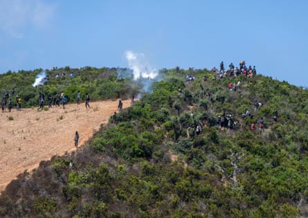 Witnesses said they saw teargas being fired at migrants on hills near the border.Photograph: Jalal Morchidi/EPA