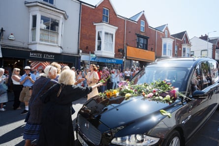 Fans pay their respects by placing flowers on the hearse carrying Welsh singer Bonnie Tyler as it travels along Newton Road to her home in Llwynderw, Mumbles, Wales.Photograph: Dimitris Legakis/EPA
