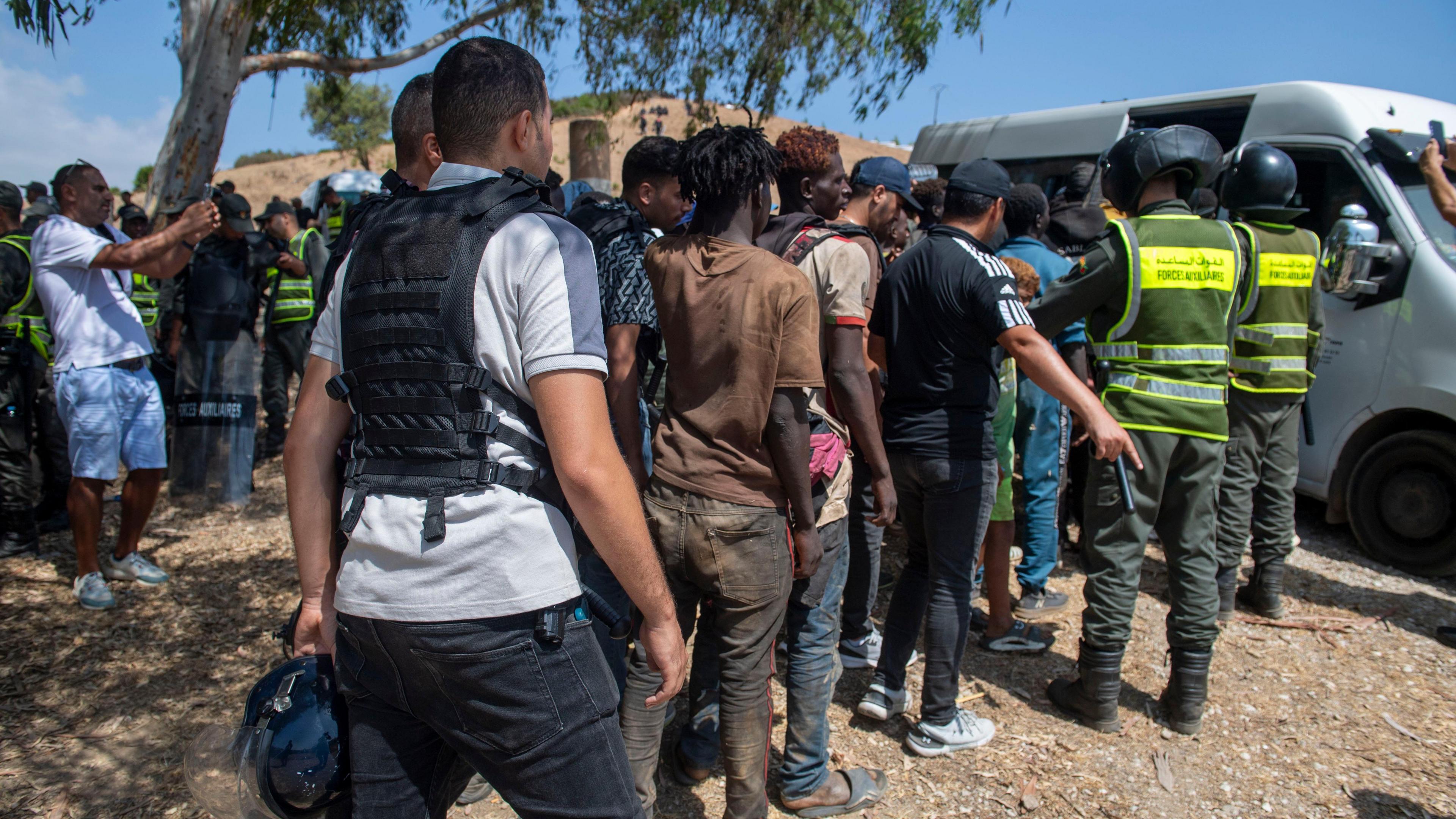 Image caption,Moroccan officials seen detaining people on Saturday