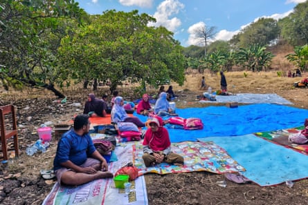 People in the coastal village of Nangahale in Sikka regency spent the night in a field.Photograph: Arnold Welianto/AFP/Getty Images