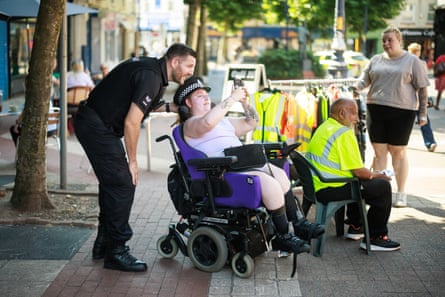 ‘Every day is a busy period,’ said the Tameside neighbourhood sergeant Rob Froggatt, here posing for a selfie in Ashton market.Photograph: Joel Goodman/The Guardian