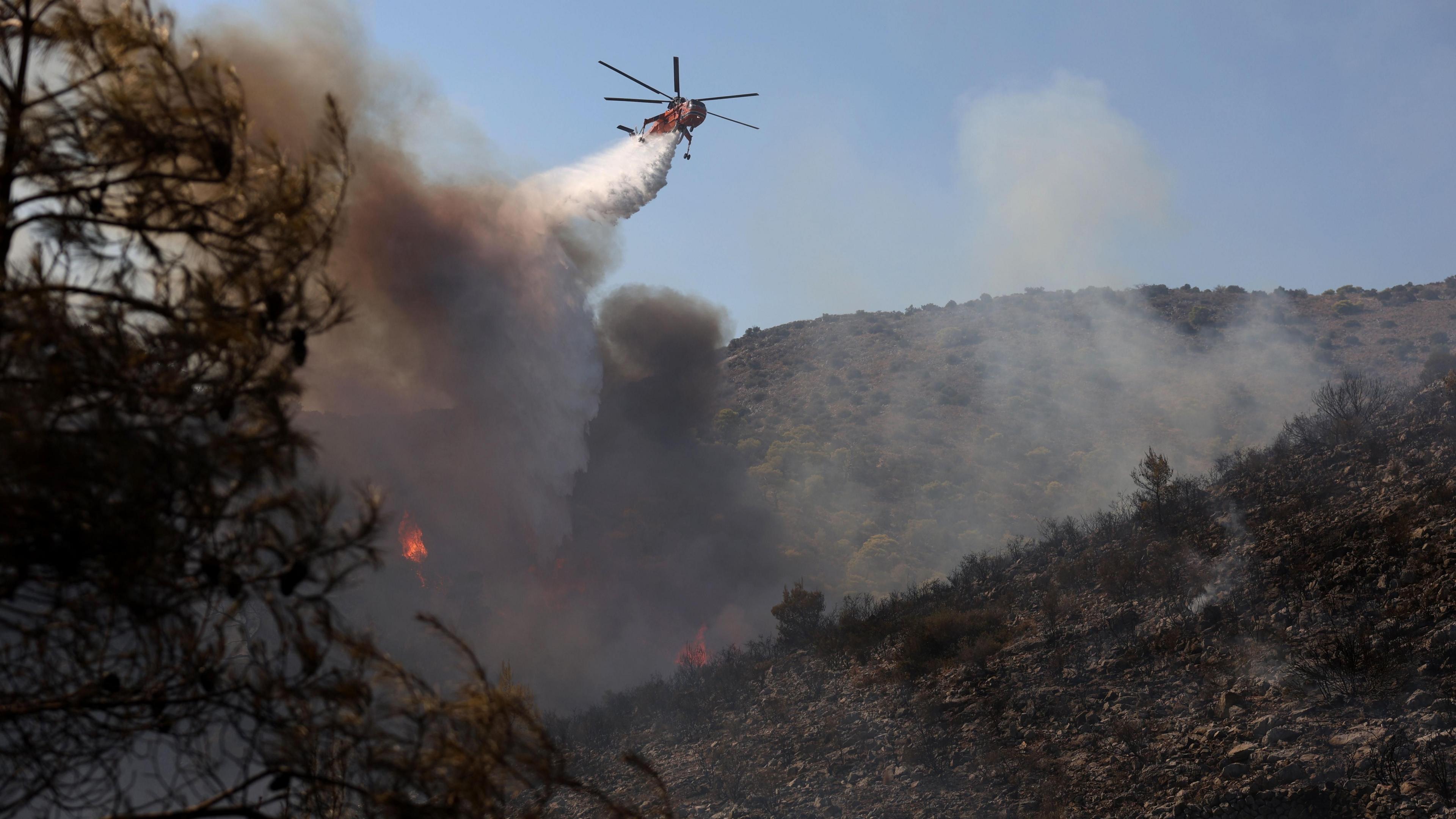 Image caption,The first fire started in a forested residential area in Peristeria