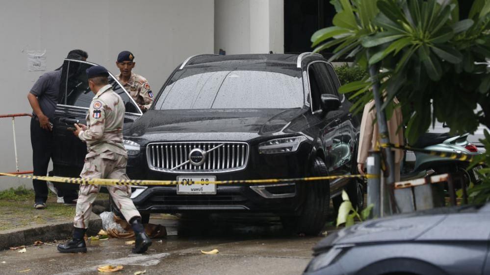 Image caption,Police inspect the scene where Chalong fired into car last week