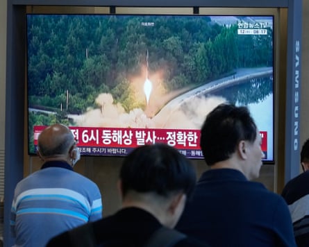 People at Seoul train station watch a news broadcast showing file footage of a North Korean missile launch.Photograph: Ahn Young-joon/AP