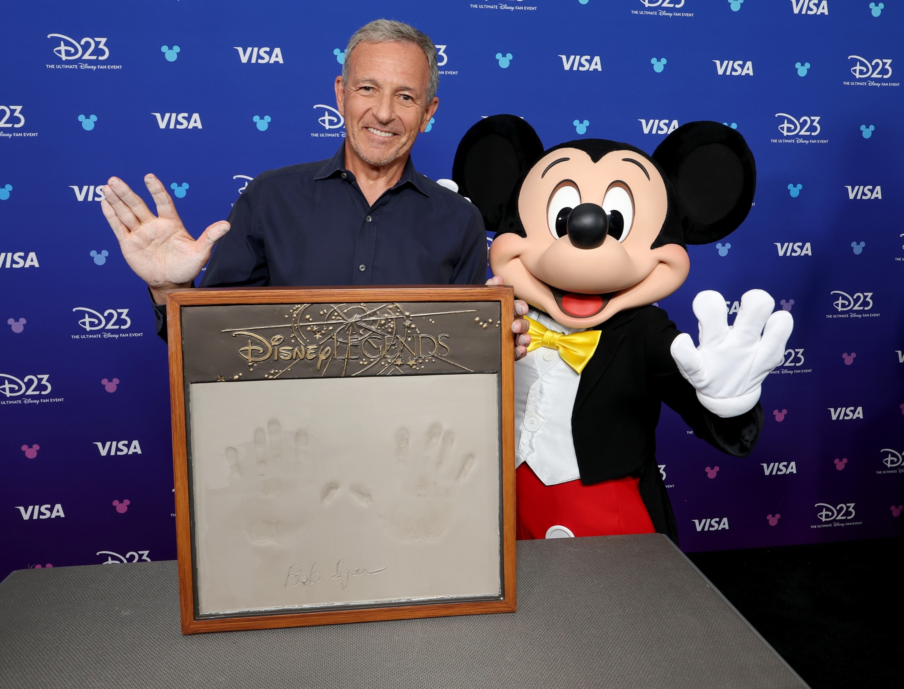 Bob Iger, Former CEO, The Walt Disney Company gets his handprints with Mickey Mouse at the Disney Entertainment Showcase at D23: Legends on August 16, 2026 in Anaheim, California.Kevin Mazur/Getty Images for Dis