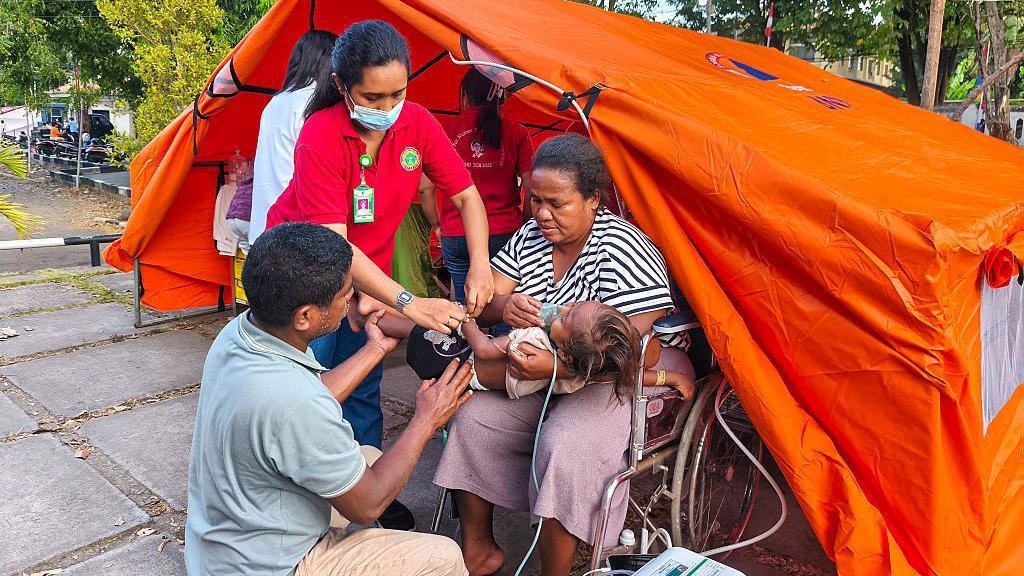 Image caption,Makeshift emergency rooms have been set up in tents after hospitals were destroyed in Saturday's devastating earthquake