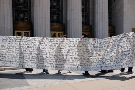 Parents who say they have lost their children due to social media hold up a banner after the jury found Meta and Google liable in a case on children’s mental health, in Los Angeles on 25 March.Photograph: Mike Blake/Reuters