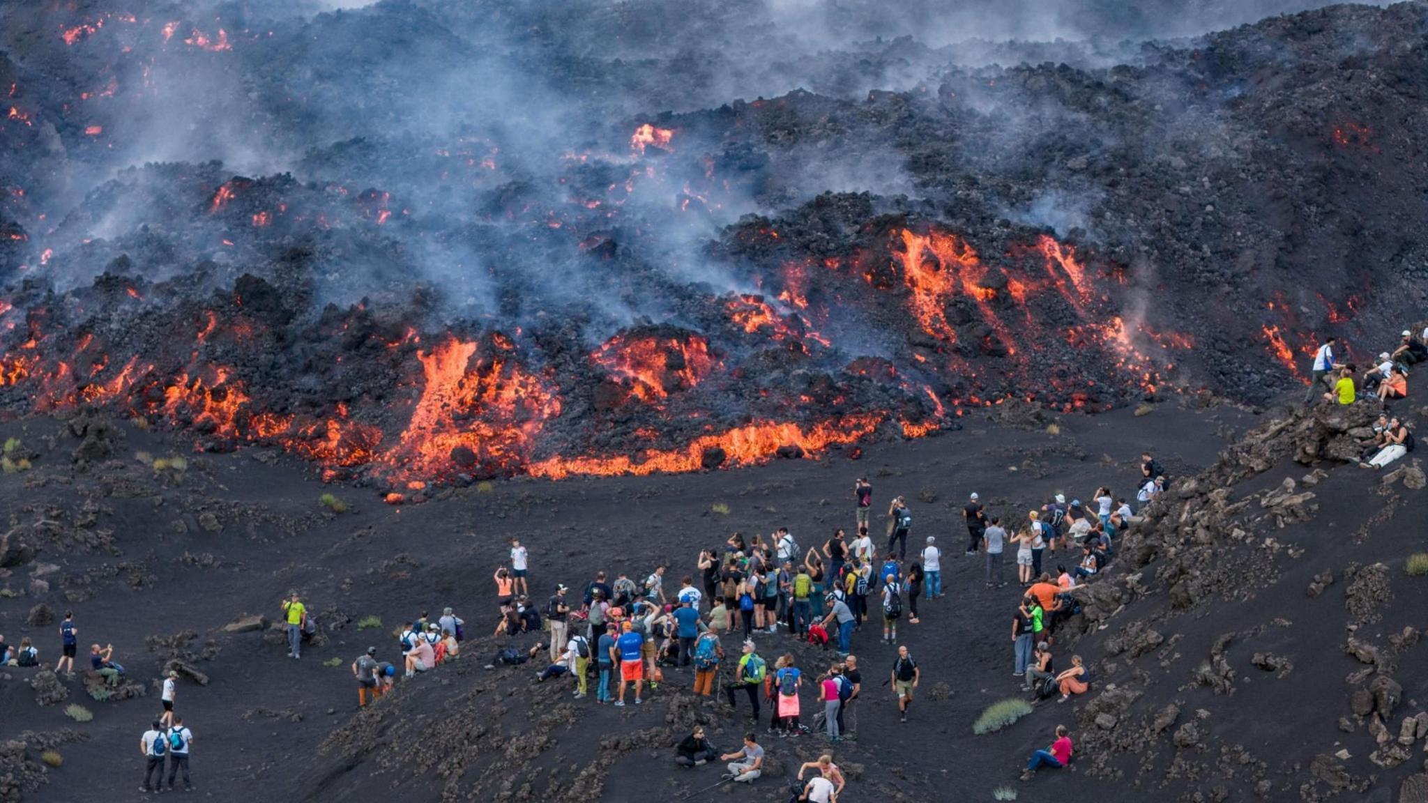 Image caption,Eruptions have attracted many tourists to Etna's slopes in recent weeks