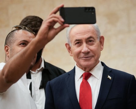 Benjamin Netanyahu poses for a selfie with a supporter as he arrives to cast his ballot in primary elections on Monday.Photograph: Ohad Zwigenberg/AFP/Getty Images