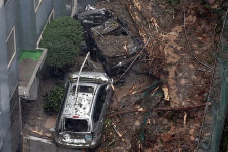 Vehicles lie crushed among the debris after a landslide caused by heavy rains in Geoje.Photograph: /Yonhap/AP