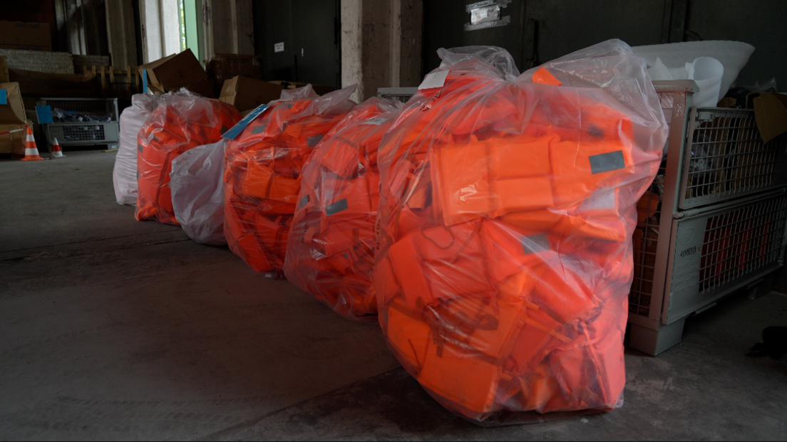 Image caption,Thousands of life jackets, covered in plastic wrapping, were seized by the German authorities in the spring