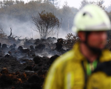 A Belgian firefighter in a field affected by a wildfire in Waimes, in the High Fens (Hautes Fagnes) region, Belgium.Photograph: Yves Herman/Reuters