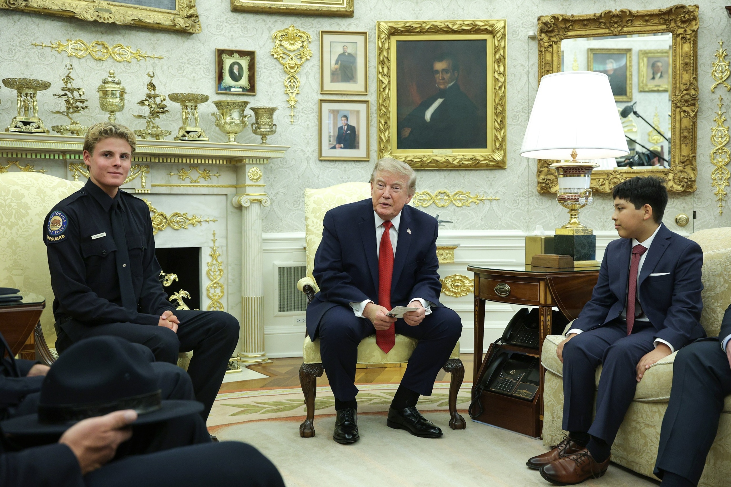President Donald Trump meets with 16-year-old California State Parks lifeguard Ryder Williams and 10-year-old Nathaniel Rai in the Oval Office at the White House on August 17, 2026 in Washington.Alex Wong/Getty Images
