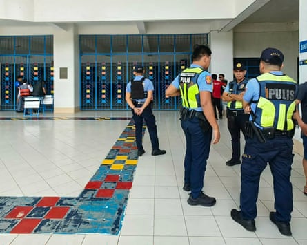 Philippine police gather at the school in Zamboanga after the shooting.Photograph: Roel Parreno/AFP/Getty Images