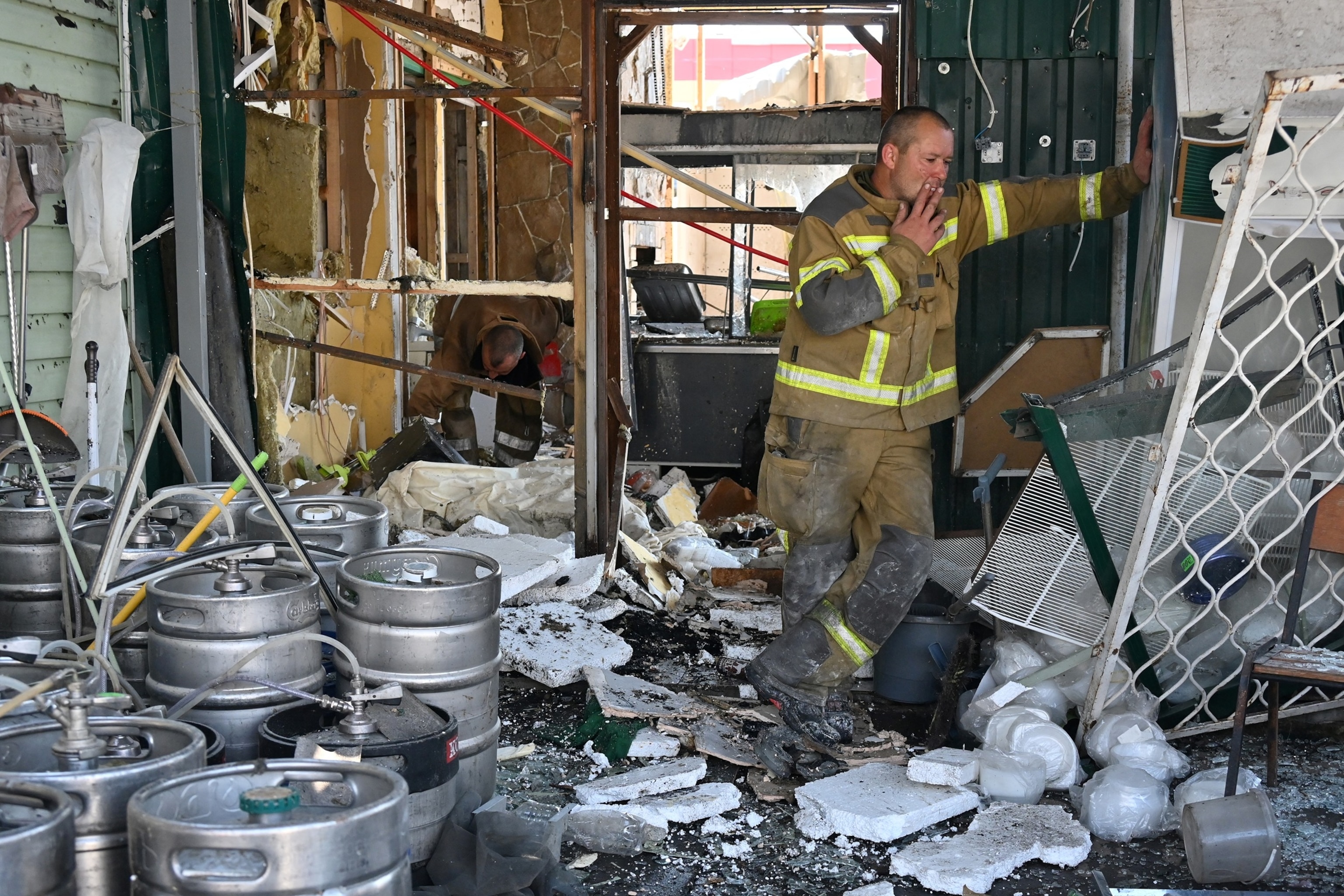 A Ukrainian rescuer smokes a cigarette at the site of an air attack in Pechenigy, Kharkiv region, on Aug. 18, 2026.Sergey Bobok/AFP via Getty Images