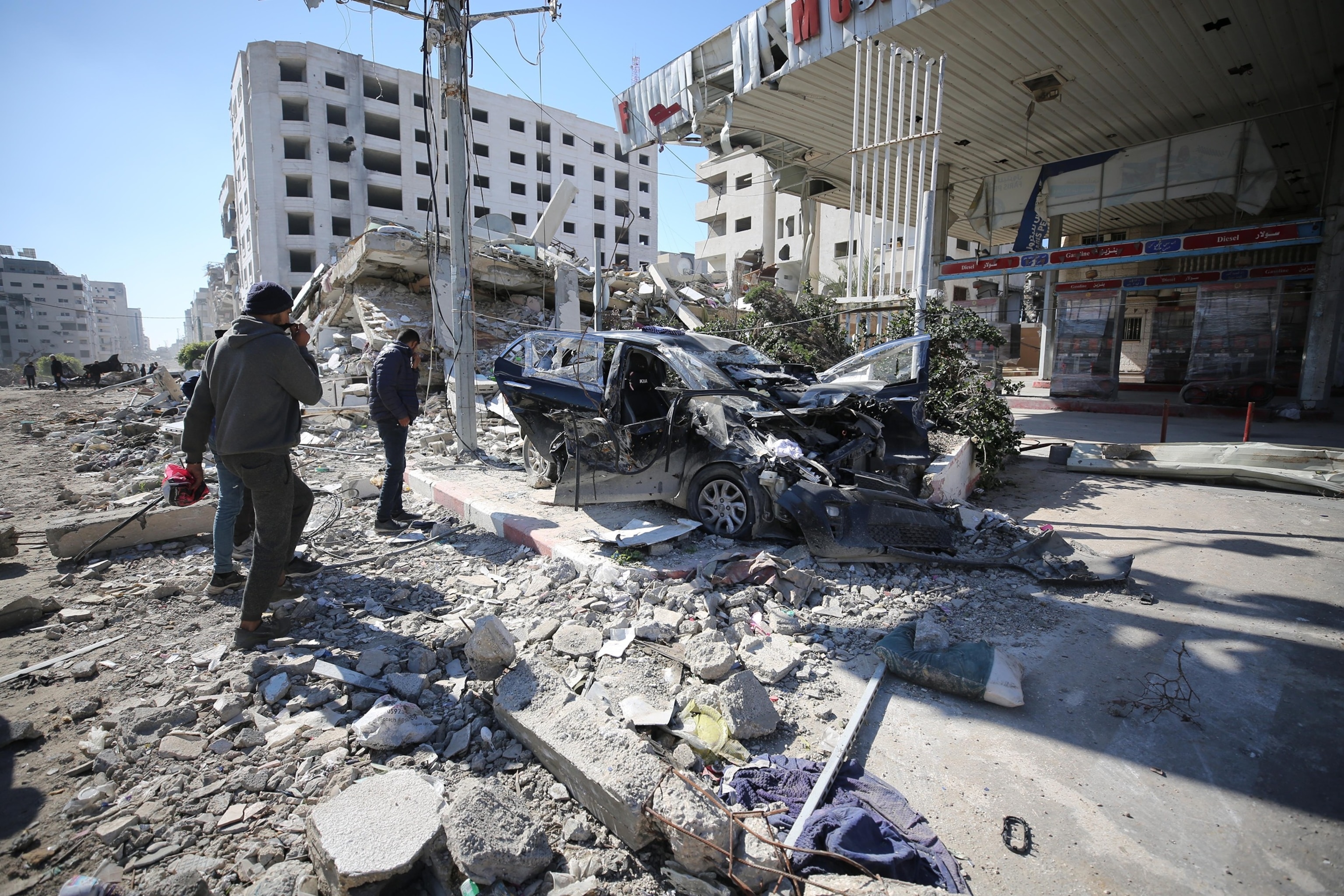 Palestinians look at the damaged car in which 5-year-old Hind Rajab and five members of her family died, whom Israeli forces targeted in Tel al-Hawa neighborhood of Gaza City, Gaza on February 10, 2024.Dawoud Abo Alkas/Anadolu via Getty Images