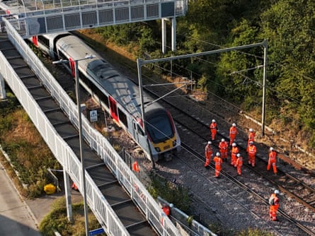 Rail workers at the scene of the Greater Anglia train derailment south of Wickford railway station in Essex, which occurred a day after the Lewes derailment.Photograph: Jonathan Brady/PA