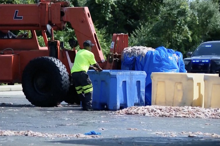 Workers clean up the spill in Narragansett.WJAR
