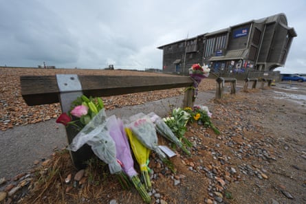 Floral tributes on the beach at Shoreham-by-Sea, near the RNLI station.Photograph: Yui Mok/PA