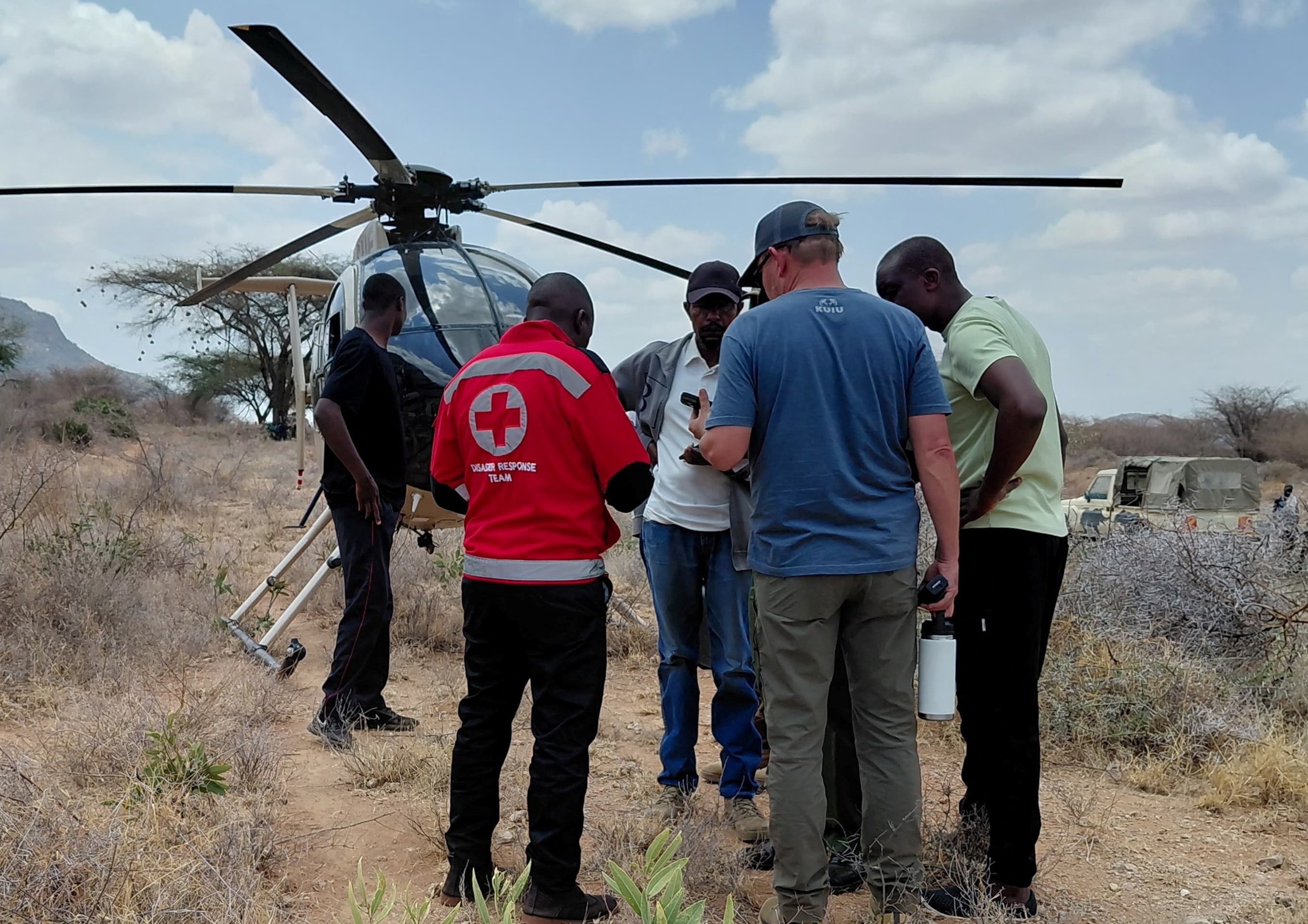 Rescue officials work at the site of a tourist helicopter crash that caused multiple casualties, according to the police, in Samburu County, Kenya, August 19, 2026.Kenya Red Cross via Reuters