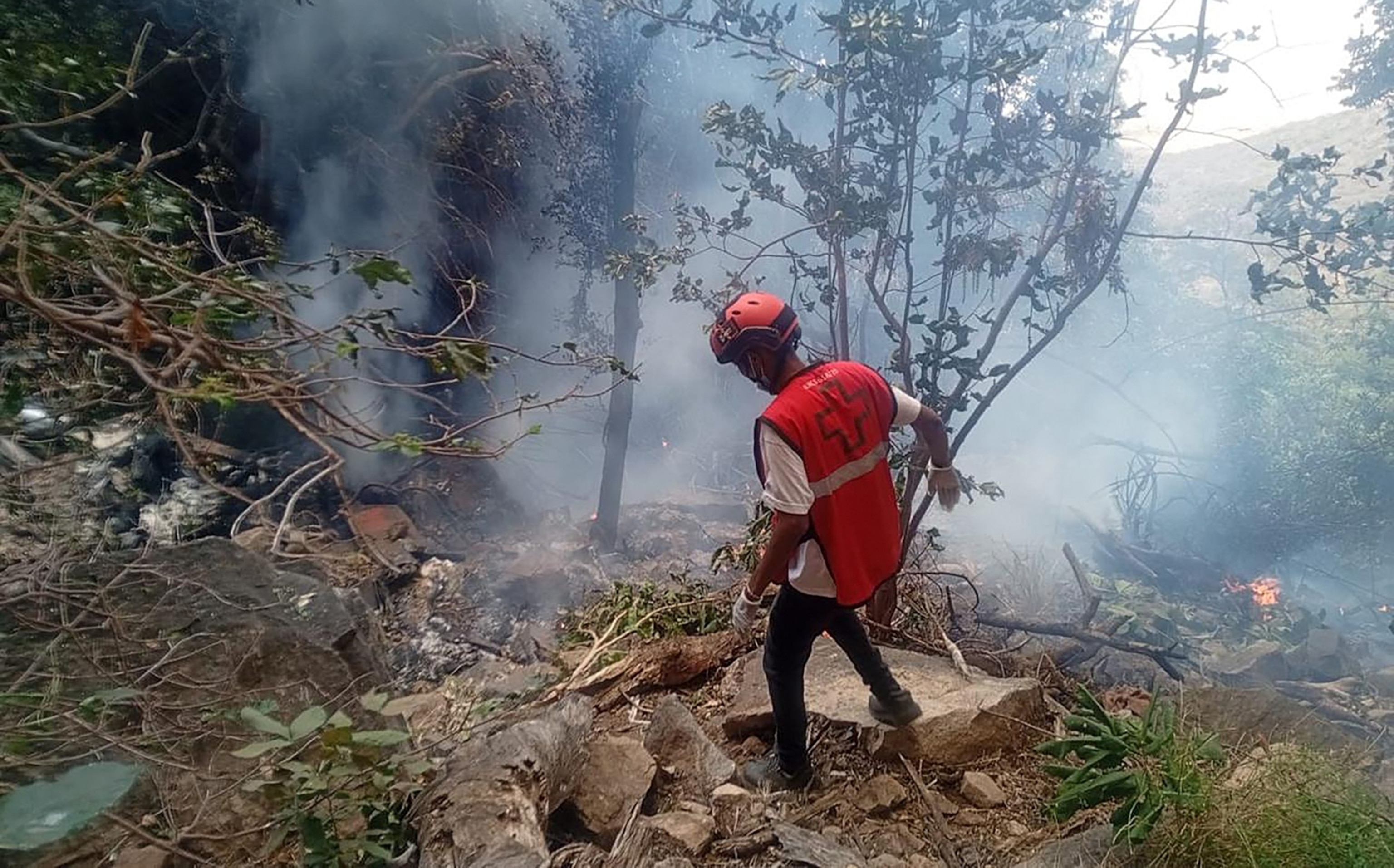 A rescue official works at the site of a tourist helicopter crash that caused multiple casualties, according to the police, in Samburu County, Kenya, August 19, 2026.Kenyan Red Cross