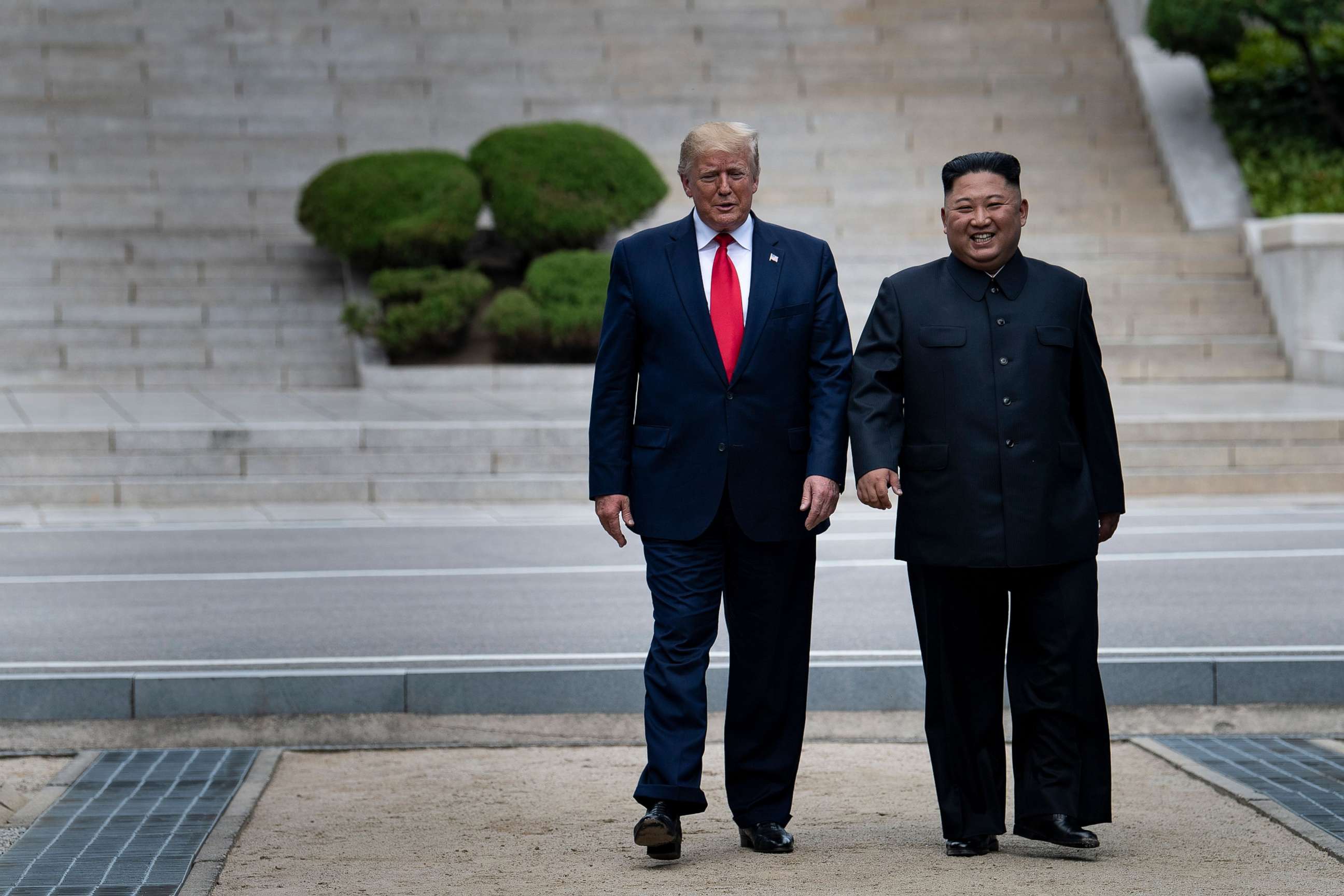 In this June 30, 2019, file photo, President Donald Trump and North Korea's leader Kim Jong-un walk on North Korean soil toward South Korea in the Demilitarized Zone, in Panmunjom, Korea.Brendan Smialowski/AFP via Getty Images, FILE