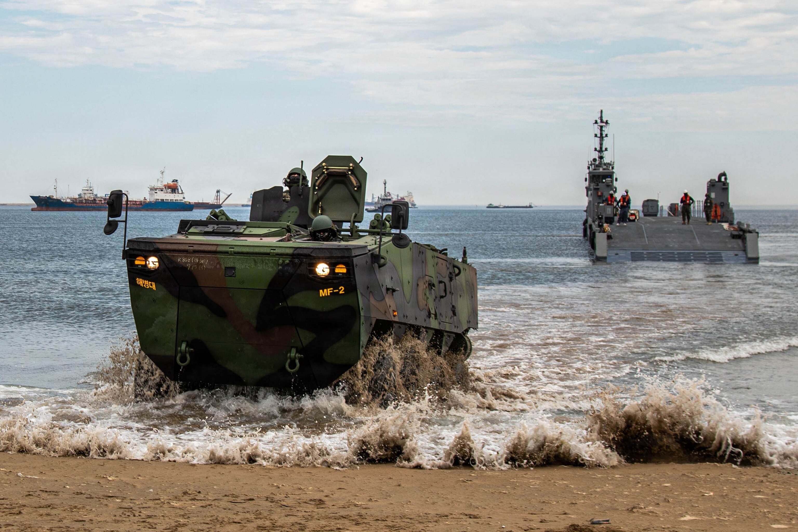 A Republic of Korea Army soldier drives a K808 wheeled armored vehicle onto the shore during an amphibious offloading demonstration for distinguished visitor (DV) day as part of the Combined Joint Logistics Over-the-Shore 2026 (CJLOTS 2026) exercise at Pohang Port, South Korea, July 16, 2026.Pfc. Yunseong Jang/U.S. Army