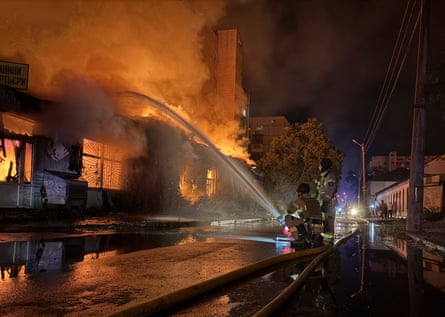Firefighters work to quell a fire at a residential building hit by a Russian missile in Kyiv.Photograph: Reuters
